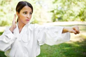 A martial artist concentrates while training outdoors.