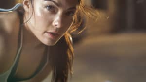 Close-up Shot of a Beautiful Athletic Woman with Anxiety Looks into Camera. She's Tired after Intensive Cross Fitness Exercise.