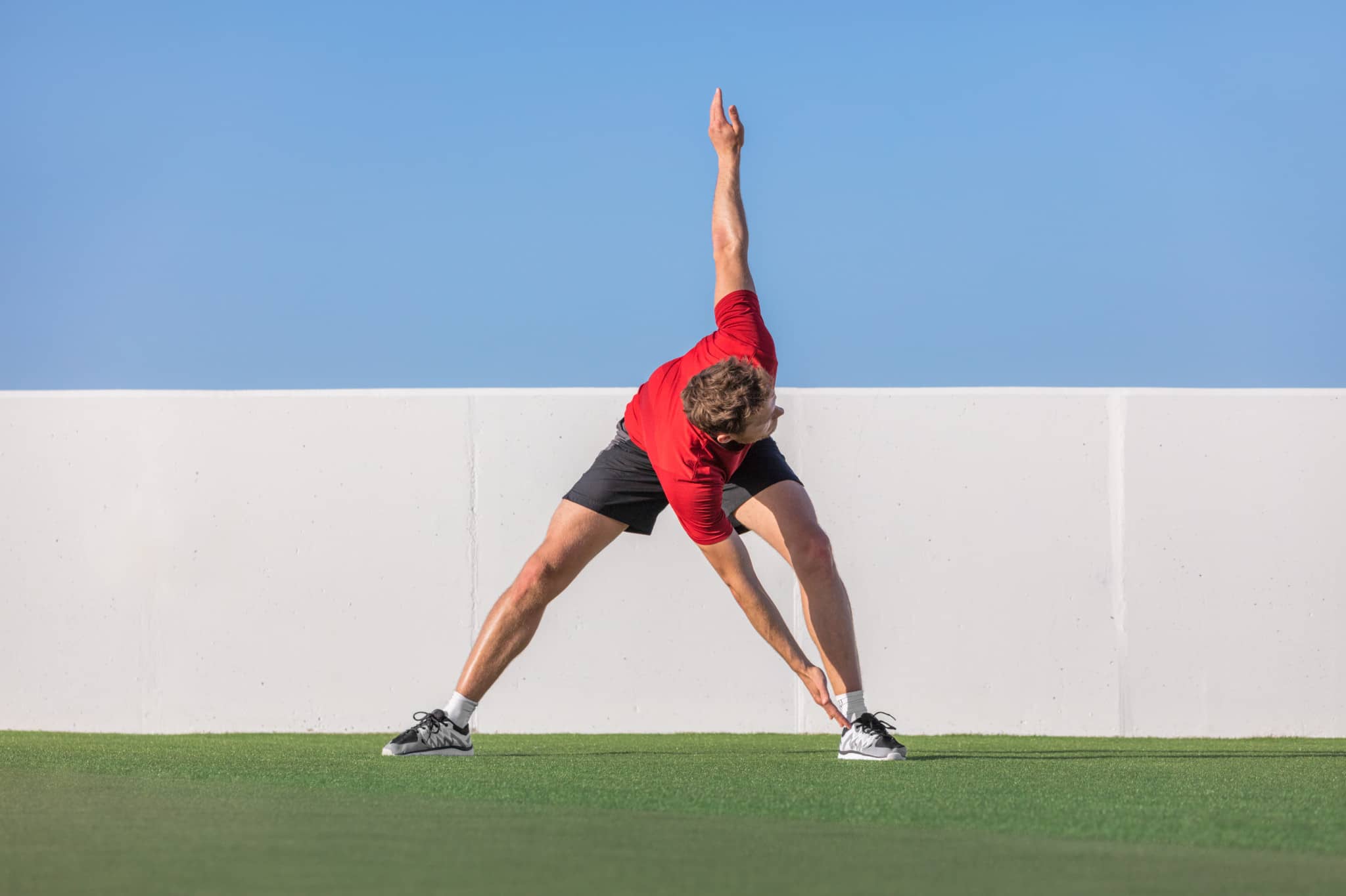 A man stretching before practicing martial arts.