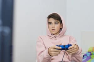 young teenager playing Fortnite.