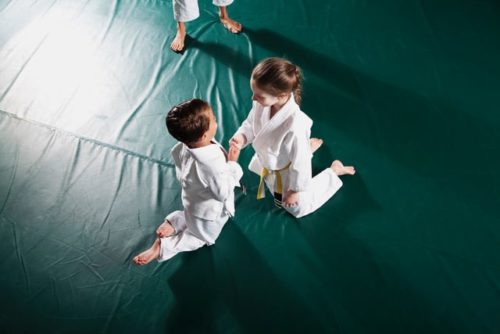 Children practicing Jiu-Jitsu, doing fist bump