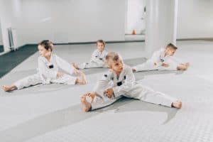 young martial arts students stretching before class