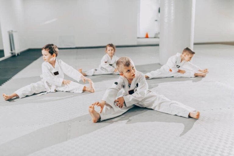 young martial arts students stretching before class