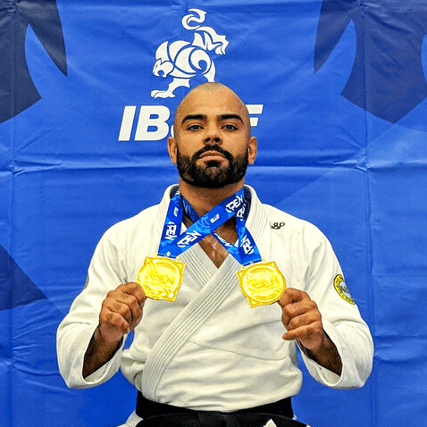 Man holding two gold medals around his neck