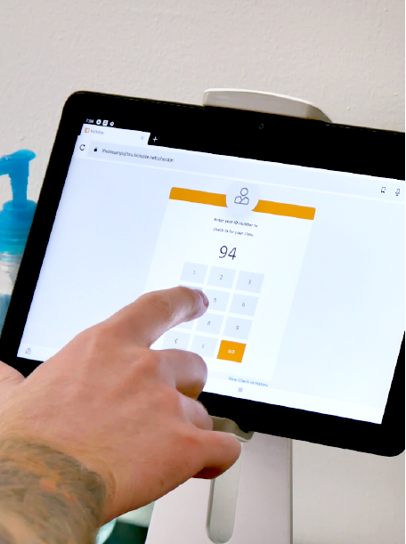 Hand typing in a PIN number on a tablet