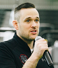 Man in Tap Cancer Out shirt speaking with microphone