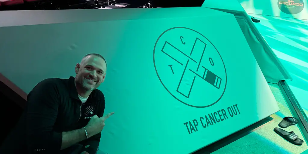 Man pointing at Tap Cancer Out logo